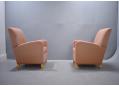 Pair of matching club chairs in salmon pink fabric.