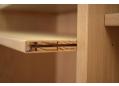 The shelves rest on hidden shelf supports and can be moved around pre-drilled holes.