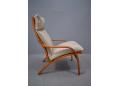 Modern reclining armchair with laminated beech frame in cherry finish.