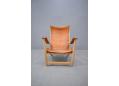 Oak frame lounge chair with tan saddle leather seat and arms. Mogens Voltelen design