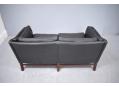 2 seat sofa in black colour leather upholstery with classic box frame. 