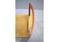 The seat & back rest is upholstered in a yellowish green fabric.