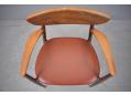 Orange-brown leather upholstered seat on rosewood armchair