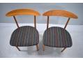 The seats are upholstered in a black / striped fabric.