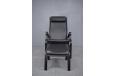 Modern Danish Design armchair with black leather upholstery and matching angled footstool