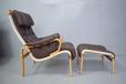 Highback armchairin brown leather with beech plywood frame
