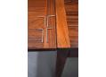 Restored rosewood dining table by Henry Kjaernulf with drop leaves.