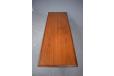 Tapering legs on Danish coffee table in teak with black vinyl wrapping