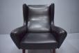Vintage black leather armchair sitting on rosewood legs design by Illum Wikkelso for Soren Willadsen Cabinetmkaer, 1961