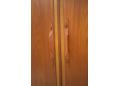 Elegant laminated teak handles appear riveted to the door face.