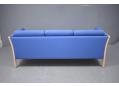 Compact 3 seat box frame sofa in blue fabric with beech frame ends. 