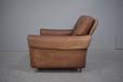 1970s Danish made low armchair with original leather upholstery.