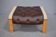 Buttoned leather angled footstool with beech legs
