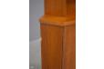 A small area of missing veneer on the left side of the cabinet
