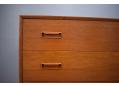 Rectangular inset teak handles are fitted on the top of each drawer front.