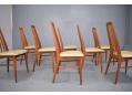 High back teak frames with cream vinyl seat upholstery