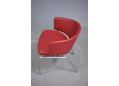Curved back red leather office chair with chrome legs.