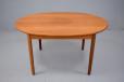 Vintage 1960s design teak dining table with oval top, extending with one extra leaf