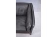 Black colour leather upholstered 2 seat sofa with supportive seating.