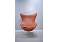 Egg chair in original brown leather upholstery. Arne Jacobsen design.