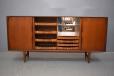 central compartments with shallow drawers on the left and mirror back drinks section and drawer on the right