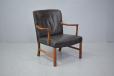 Vintage rosewood armchair with black leather upholstery by Ole Wanscher