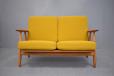 Oak frame 2 seat Cigar sofa by Hans Wegner with teak arms.