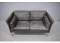 Box frame 2 seat sofa with original worn leather and wooden legs.