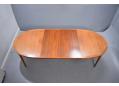 Extending oval top dining table with 2 leaf extensions in teak.