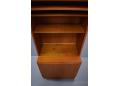 Teak wall unit made by Poul Hundevad & Co with cupboard door base.
