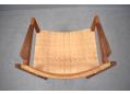 Original woven cane back rest on teak armchair made in Denmark.