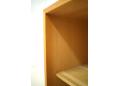 The shelves are adjustable and can be moved along pre-drilled holes.