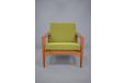 Model LARS armchair with green boucle fabric upholstered cushions.