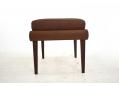 Midcentury design rosewood legged footstool in brown leather.