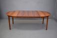 Fully extended round dining table in rosewood. Able to seat 8-10 