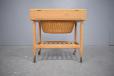 Spacious sewing table with lif-up top that reveals compartemented space for smalls required 