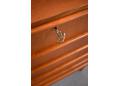 Lipped teak handles are fitted on the top of each drawer front.