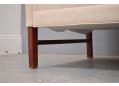 The sofa stands on 4 mahogany finish wooden legs.