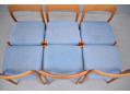 Rich teak frames contrast the blue fabric upholstery.