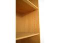 The shelves in the bookcase top can be moved along pre-drilled holes.