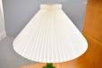Vintage table lamp with pleated paper shade and green glass base