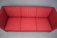 3 seat 1950s box frame sofa with red striped fabric upholstery.