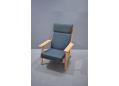 High back plank chair designed by Hans Wegner in grey-blue fabric upholstery.