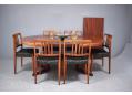 Rosewood extending dining table with round top on pedestal legs. 