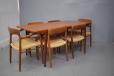 The model 56 and model 75 chairs designed to accompany this table. The armchairs fit neatly underneath at the ends