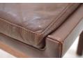 Feather-filled cushion in brown leather on rosewood ottoman / footstool.