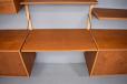 PS System in teak with stripped wall mounted uprights and abundance of movable shelves and cabinets