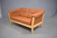 Compact 2 seat sofa in beech and tan leather upholstery.