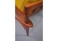 The rear leg has been designed to fit THROUGH the arm on Poul Jeppesen produced chairs