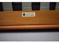 Maker's label is located on the underside of the teak frame.